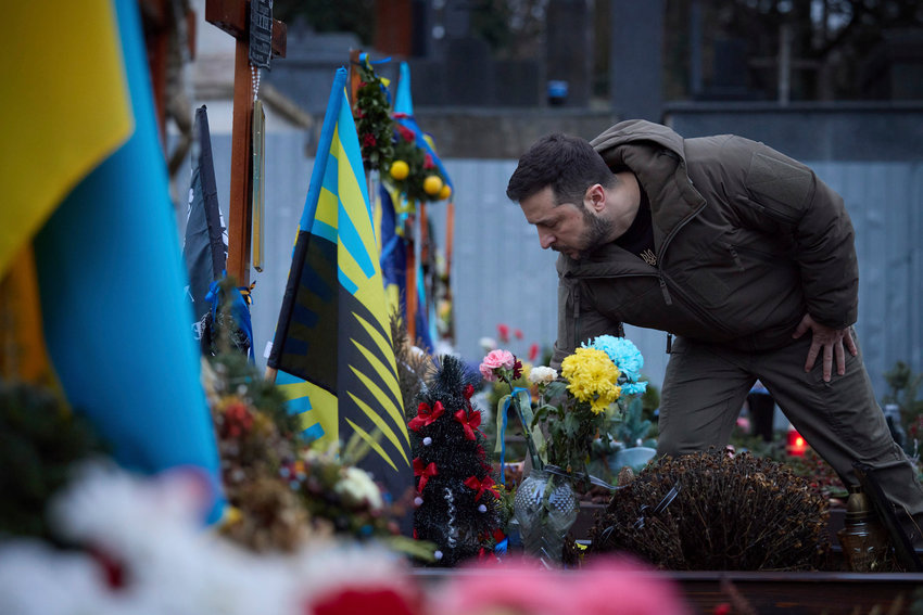 Ukrainian President Volodymyr Zelenskyy, pays tribute at a monument to Fallen Defenders of Ukraine in the Russian-Ukrainian War in Lviv, Ukraine, Wednesday, Jan. 11, 2023.