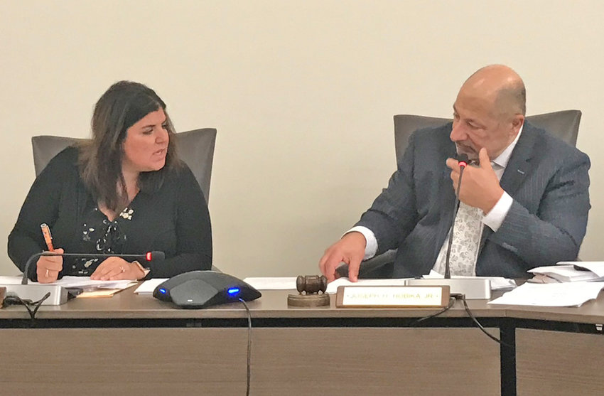 Utica City School District Board of Education Vice President Danielle Padula, left, chats with board President Joseph Hobika Jr. Tuesday, Jan. 24 during the board's regular monthly meeting in Utica.