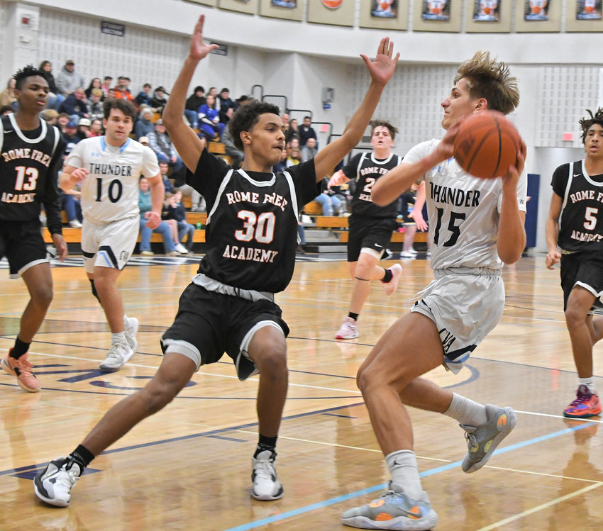Rome Free Academy&rsquo;s Surafia Norries defends Central Valley Academy&rsquo;s Deacon Judd as he drives to the basket during Friday night&rsquo;s Tri-Valley League game in Ilion. Judd tallied a triple-double with 18 points, 12 rebounds and a school-record 10 blocks in CVA&rsquo;s 76-64 win.