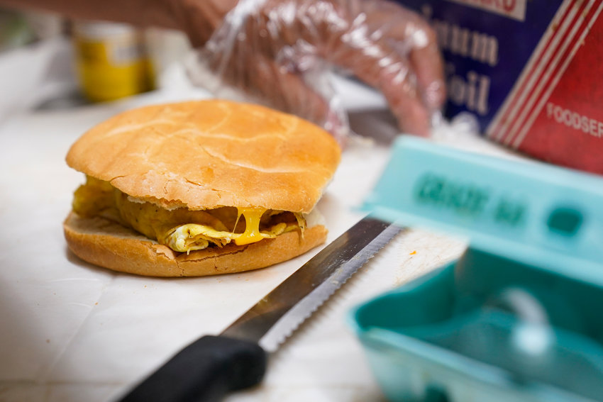 Hector Perez prepares to wrap a bacon, egg and cheese sandwich at a bodega in New York City in this file photo. Some hotels are revamping their offerings to try to change the minds of even the most skeptical travelers, offering healthier, customizable choices that include DIY yogurt bowls and higher-protein dishes, plus more flexible eating hours.
