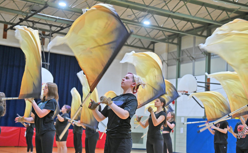 Members of the New Hartford Winter Guard warm up at the Myles Elementary School recently.  The group has a busy schedule ahead, including a trip to the Winter Guard International (WGI) World Championships, in Dayton, Ohio, in April.
