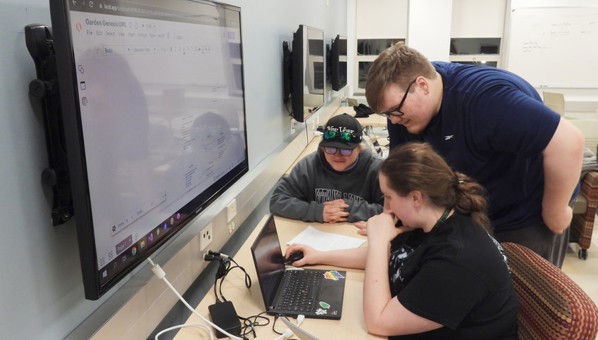 Participants of the SUNY Morrisville 2023 Global Game Jam got right to work on opening day, Friday, Feb. 3, working on a game due on Sunday, Feb. 5. Look for an article in the Tuesday edition of The Daily Sentinel. Pictured is Chino Beach at the computer, Alex Woods standing, and Grace Fowler.