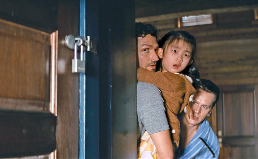 Ben Aldridge, left, Kristen Cui, center, and Jonathan Groff in a scene from &ldquo;Knock at the Cabin.&rdquo;
