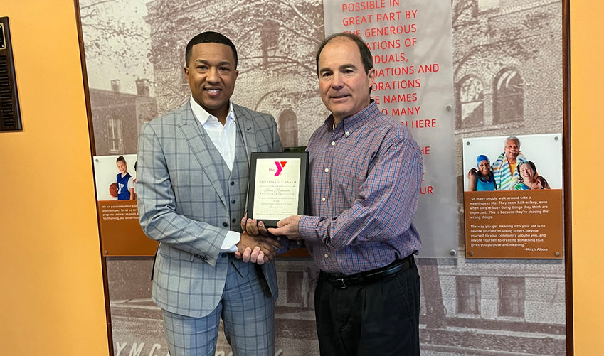 Roman Karim Madmoune, left, receives the Red Triangle Award from YMCA of the Greater Tri-Valley CEO Hank Leo.