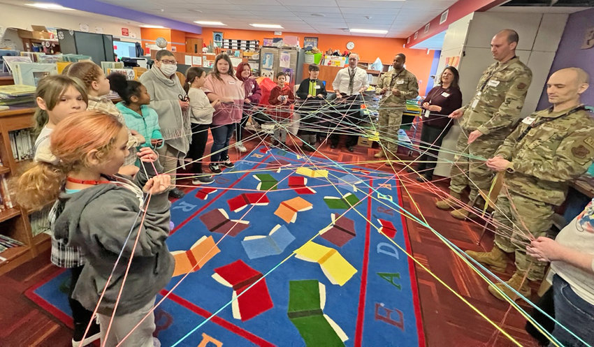 Students and mentors work on a string activity recently at Denti Elementary School in Rome. The school district has recently resumed its mentoring program for elementary school-aged kids.