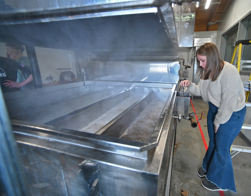 Madison Nolley, a junior at Stockbridge Valley Central School, checks the float while maple sap is boiled down Wednesday, Feb. 15 at the school FFA chapter&rsquo;s sap house. The float shows the amount of sap that is in the boiler at any time and more sap is allowed into the boiler as the level goes down.