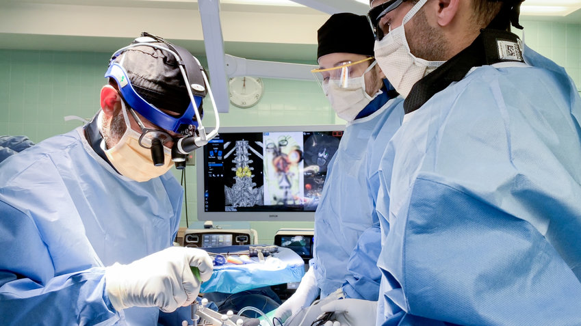 Dr. Nicholas Qandah, performs spinal surgery on a patient using technology that maps the patients spine which then creates a 3D image to assist Dr. Qandah during surgery.                                            (Photo submitted)