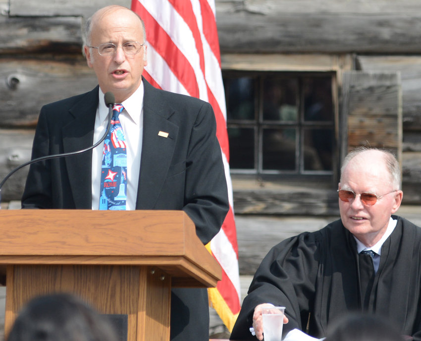 Bill Guglielmo, at the podium, speaks at a naturalization ceremony to welcome new citizens in this September 2013 file photo of a ceremony at the Fort Stanwix National Monument.
