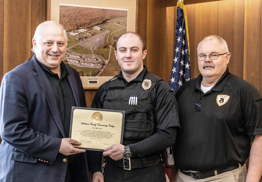 Joshua Muzzi, center, has been appointed as a new campus peace officer at Herkimer County Community College. From left: Nicholas F. Laino Sr., vice president for administration and finance; Muzzi; and Timothy Rogers, director of campus safety.
