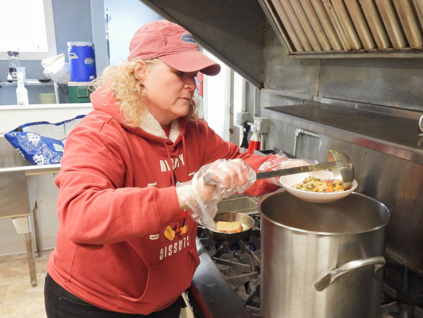 Faith Musachio, of Canastota, volunteers at Church on the Rock in Oneida, helping serve hot meals to those in need.