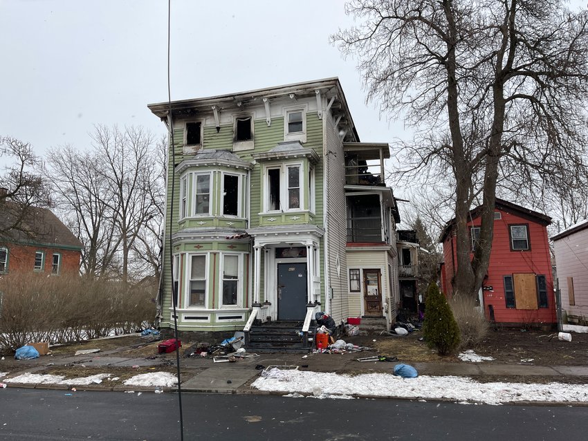 Pictured is 422 Mandeville St. in Utica on Monday, March 13. Upwards of 15 people fled a house fire there, on Sunday evening. A non-live utility line dangles in the foreground.