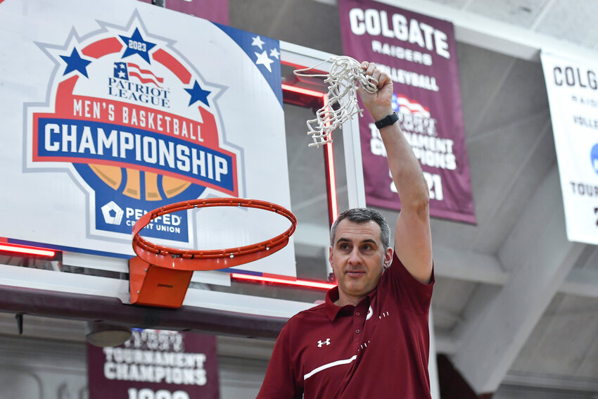 Colgate coach Matt Langel cuts down the net after his team&rsquo;s win against Lafayette in the Patriot League Tournament championship on March 8 in Hamilton.