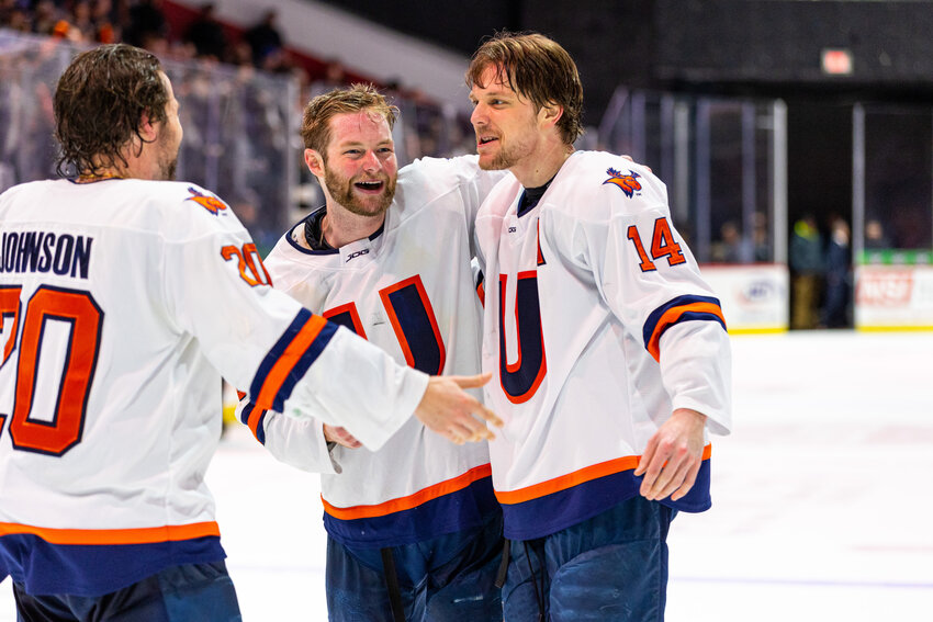 Regen Cavanagh, center, and Justin Allen, right, celebrate after Utica University won the team&rsquo;s conference title earlier in March. Cavanagh and Allen have signed tryout contracts to join ECHL Norfolk.