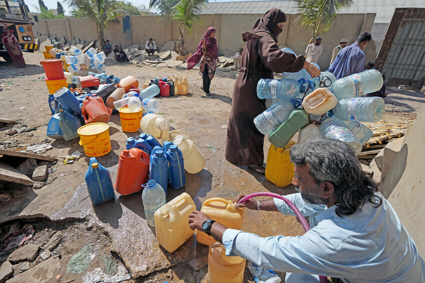 People get drinking water from a water collecting point at a slum area, in Karachi, Pakistan, Tuesday, March 21. World Water Day was observed on March 22, to aim to highlight the importance of freshwater and advocate for sustainable management of this vital resource.