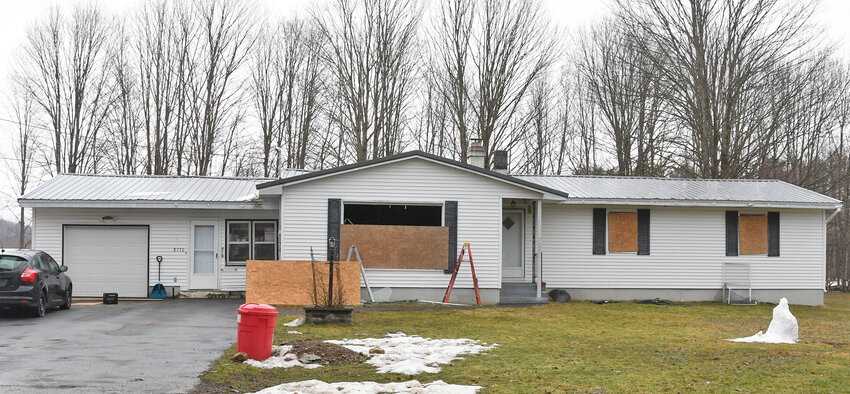Windows are boarded up following a house fire at 8730 Davidson Road in the Town of Lee from Wednesday night. The cause of the fire may have been electrical, according to the Lee Center Fire Department.