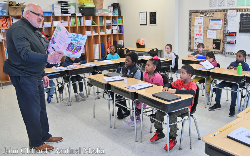 Interim superintendent Brian Nolan reads &quot;The Little Butterfly that Could&quot; to Doris Testa's third grade class during the Community Reader's Day event at Kernan Elementary School Friday morning.
