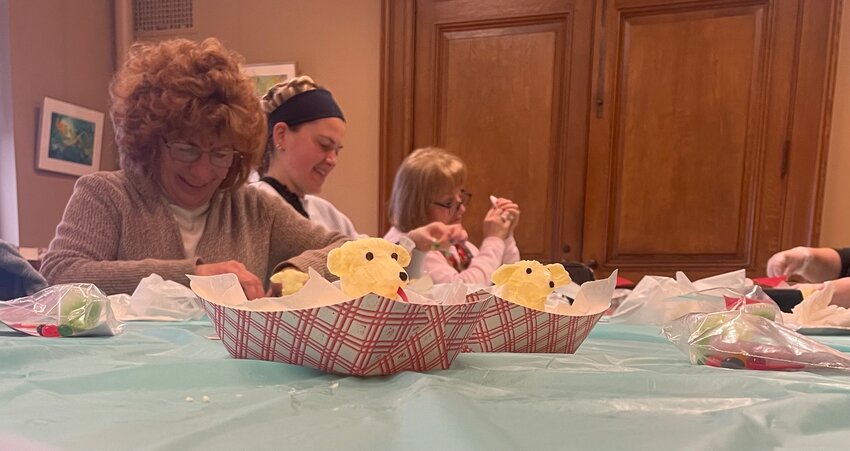Participants in the Utica Public Library&rsquo;s lamb workshops on Saturday, March 25. The finished butter lambs sit in containers, ready to be taken home for Easter dinner.
