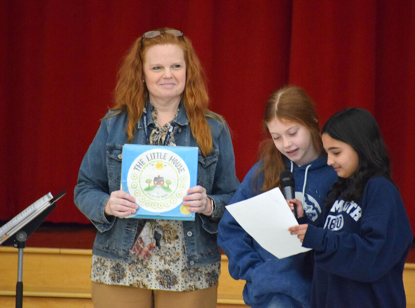 Herkimer Elementary School kicked off its Pick a Reading Partner program for this school year with an assembly on Monday, March 20. Among those in attendance were, from left: Jennifer Olds, Herkimer Elementary School library media specialist, holding the book &ldquo;The Little House&rdquo; and fourth-graders Sofie Burns and Aryanna Farington, who talk about the book.