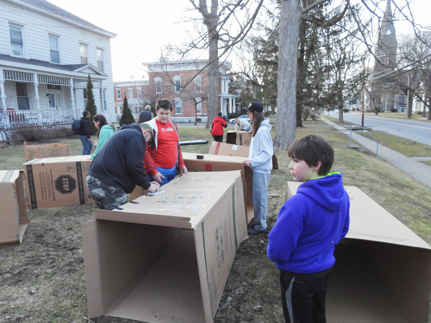 Oneida Scout Troop #2 sets up their cardboard shelters for the homelessness awareness sleep-out