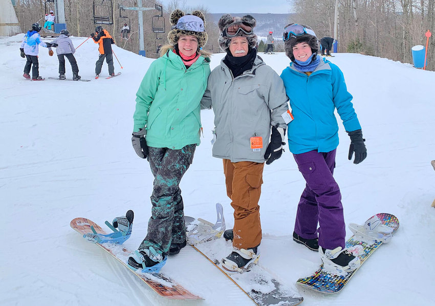 Amanda, Clifford, and Sabrina Crandall enjoying a family day of snowboarding.