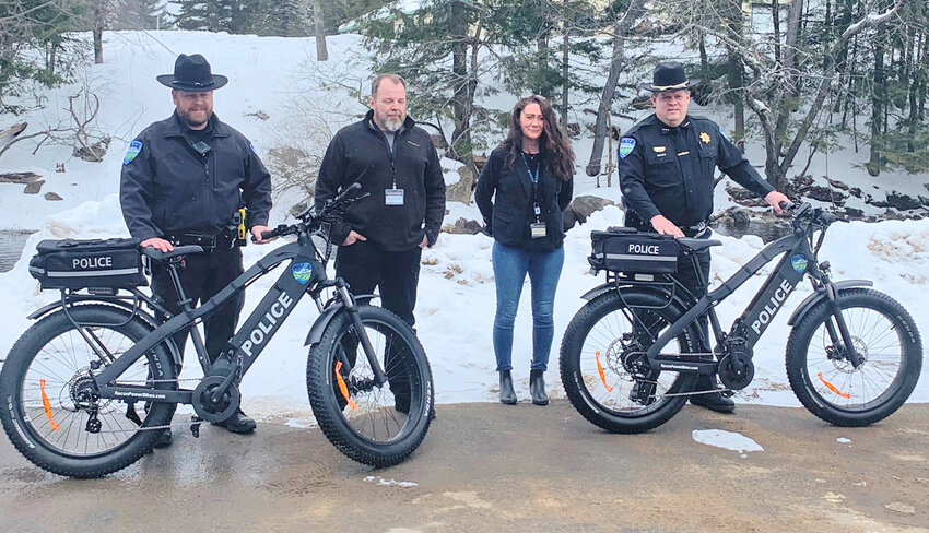 The Town of Webb Police Department has added two electronic patrol bicycles to their agency, thanks to a grant from Catholic Charities of Herkimer County. From left: Police Officer Jamie Furlong, Catholic Charities employees Jeff Petrie and Brandy Staring, and Police Chief Ronald Johnston.