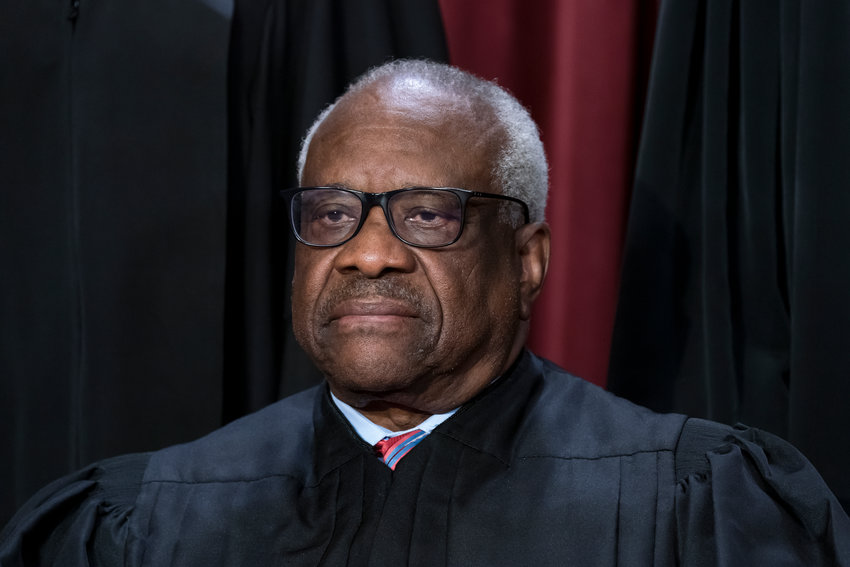 Associate Justice Clarence Thomas joins other members of the Supreme Court as they pose for a new group portrait, at the Supreme Court building in Washington, Oct. 7, 2022. Thomas has for more than two decades accepted luxury trips nearly every year from Republican megadonor Harlan Crow without reporting them on financial disclosure forms, ProPublica reports.