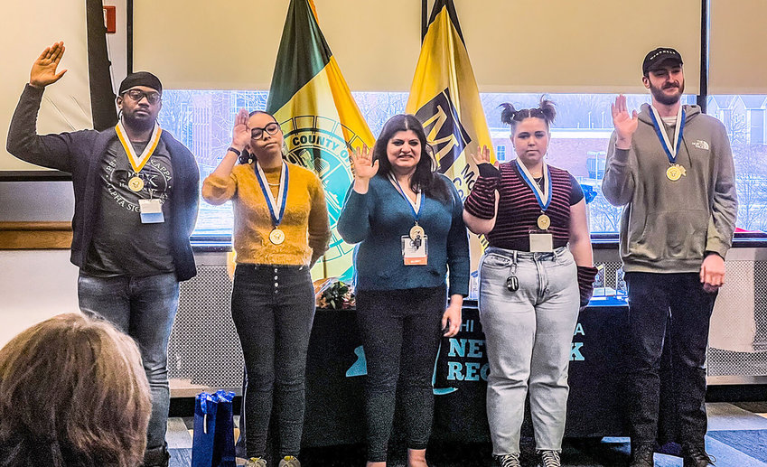 Margaret Skourlis, center, who graduated in 2021 and has returned to Herkimer College to pursue legal studies, is sworn in as Phi Theta Kappa northern vice president for the New York region in Rochester.