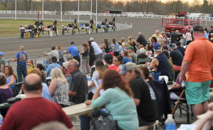 A crowd of over 1,700 spectators watch the second race thunder down the front stretch at Vernon Downs to the first turn during Saturday night&rsquo;s 70th season opener at the historic racetrack in Vernon.