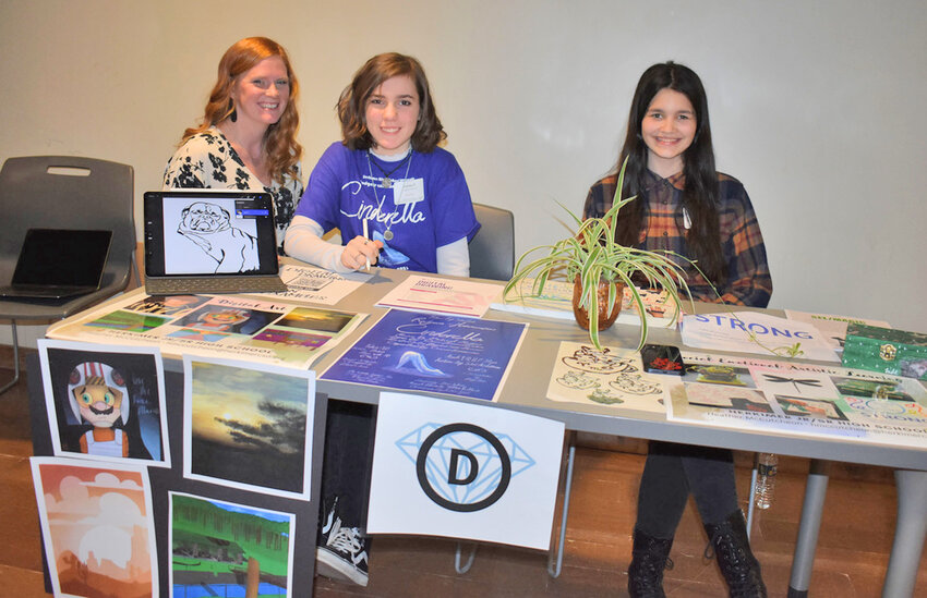 Herkimer Central School District art teacher Heather McCutcheon, left, Herkimer sophomore Jillian Hutchinson, center, and Herkimer junior Lyndsey Voorhees present about digital art and social emotional artistic learning Thursday, March 16 during the Oneida-Madison-Herkimer Counties School Boards Institute Educational Showcase in Herkimer.