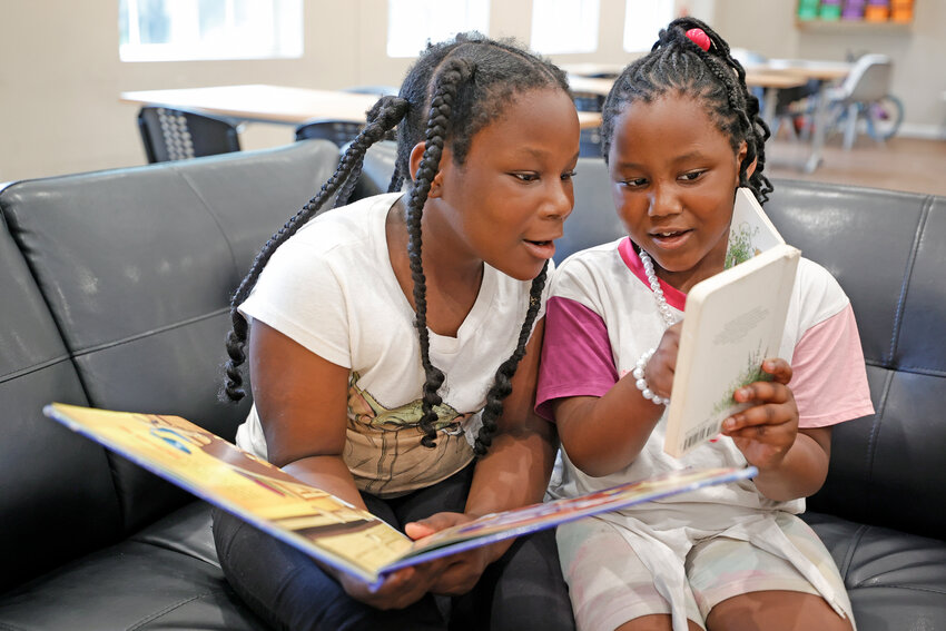 China Nash, 8, left, and Star Shields, 7, read together during a daily after-school literacy program in Atlanta on Thursday, April 6. The after-school program is open to students in kindergarten through fifth grade through the Atlanta based Pure Hope Project.