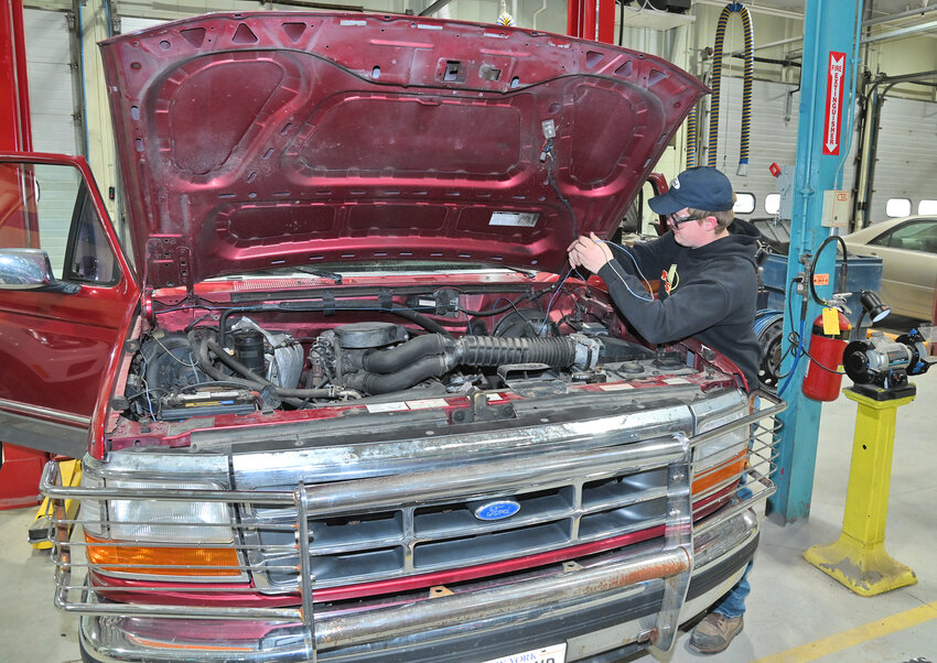 Dante Brown, a VVS High School student, works on the wiring of his FORD F150 truck Wednesday, April 19 at the Madison-Oneida BOCES Career and Technical Education Open House in Verona.