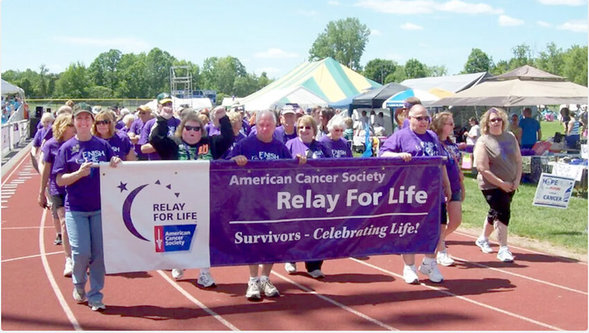 Purple-shirted cancer survivors walk their own lap during a previous American Cancer Society Relay for Life event.