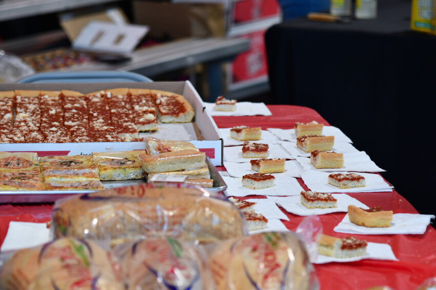 Slices of Napoli's tomato pie were up for the taking as five tomato pie vendors handed out samples of the iconic Utica delicacy during the annual Tomato Pie Day event in Utica on Saturday.