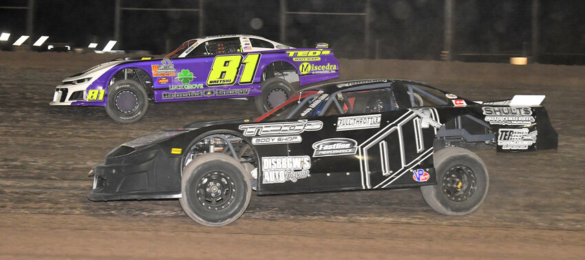 DOOR-TO-DOOR &mdash; Bret Belden, No. 81, and Josh Coonradt, No. 00, raced for the lead door-to-door for most of the pro-stock feature race on Friday night at Utica-Rome Speedway. Belden ended up winning the pro-stock feature and Coonradt finished 11th after washing up over the berm while making a last ditch effort to get the lead on the final lap.