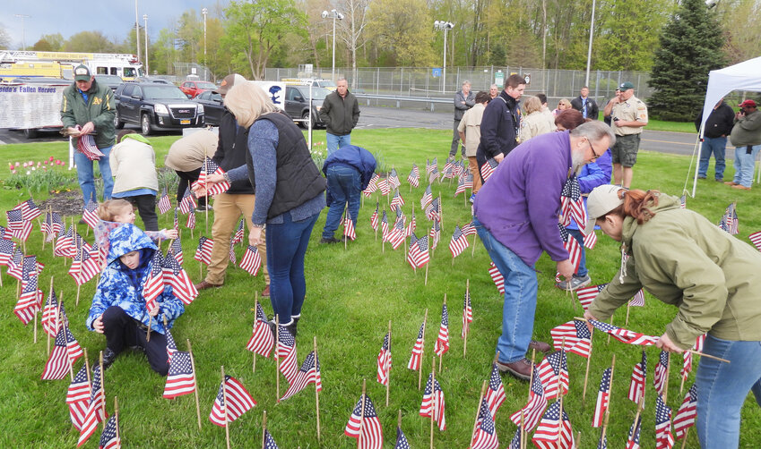 Oneida city residents and local residents come together to plant the Memorial Flag Garden on Monday, May 1.