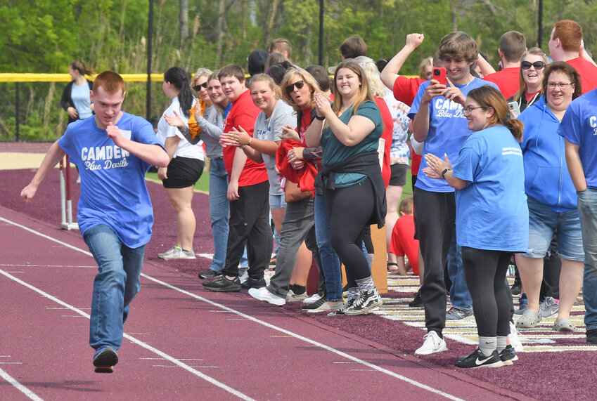 Camden's Nate Tubiewicz gets cheered as he runs the 50-meter sprint Tuesday, May 9 at the Special Olympics Spring Games in Canastota.
