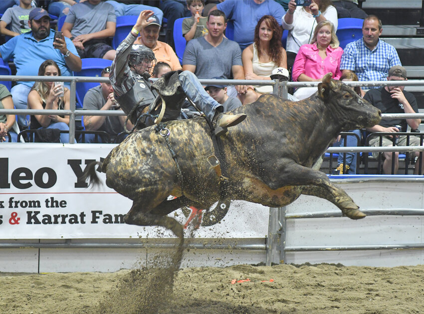 A bull rider catches air during a rodeo event in 2019 at the Adirondack Bank Center. The rodeo is set to return to the downtown Utica arena in early August.