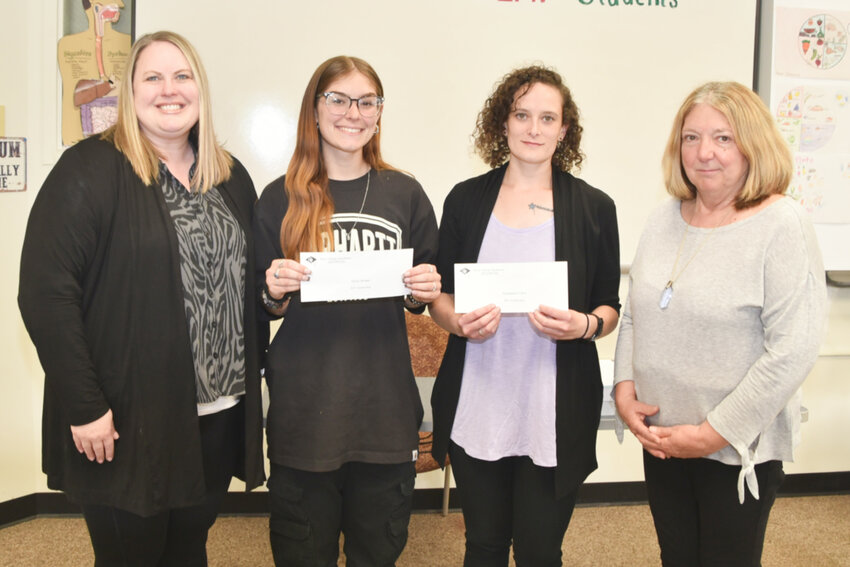 RCF Treasurer Brenda McMonagle, left, and RCF President and MOBOCES Board of Education member Sue Carvelli, right, pose with scholarship recipients Emily Brown and Cassandra Card.