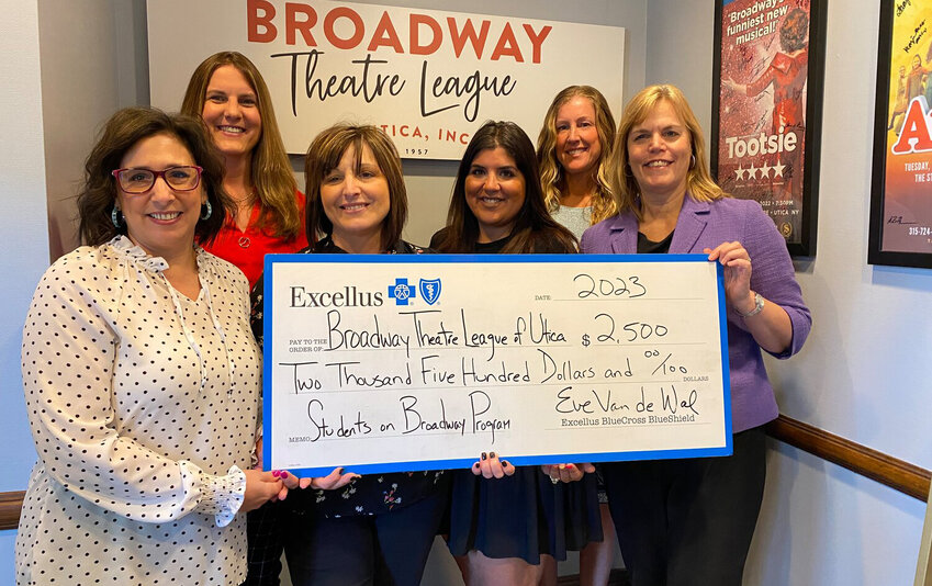 Members of the Broadway Theatre League and Excellus BlueCross BlueShield hold a ceremonial check following an announcement that the Students on Broadway Program has been awarded a $2,500 Health and Wellness grant.