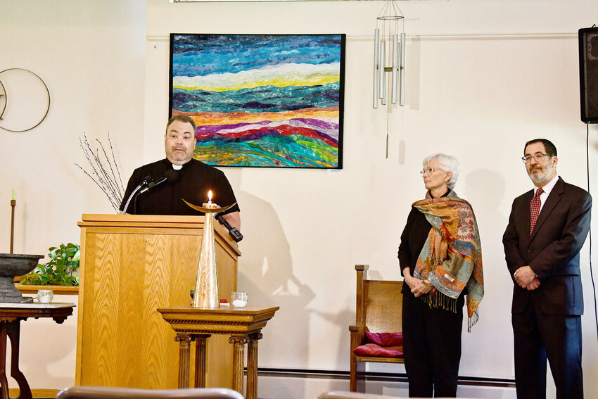 From left, Rev. Michael Ballman of Cornerstone Community Church, speaks out about Oneida County&rsquo;s housing ban for migrants, while Rev. Karen Brammer of the Unitarian Universalist Church of Utica and Rabbi Peter Schaktman of Temple Emanu-El, stand in support.