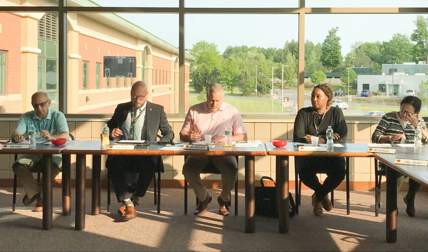 Rome City School District Board of Education member John Nash, district Superintendent Peter Blake, board President Joseph Mellace, board Vice President Elena Reddick and board member Karen Fontana conduct district business Monday, May 22 in the Rome Free Academy library.