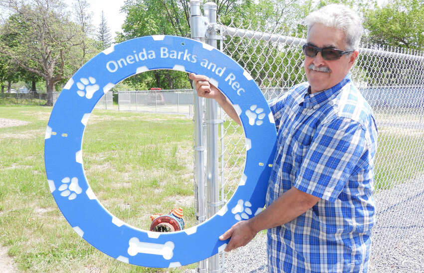 OIC Member and Volunteer Joseph Magliocca holds up one of the tire jumps that will be installed in the Oneida Dog Park