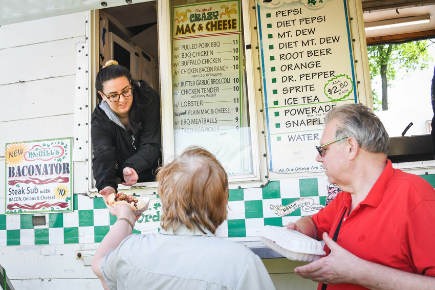 Destiney McDavid serves customers food at McGill&rsquo;s food truck at last year&rsquo;s What the Truck food event in Utica.