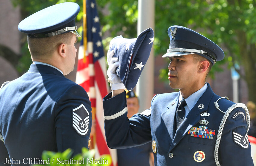 EADS Honor Guard members Air Force Staff SGT Charles Saenger presents a folded flag to Master SGT Ryan LaClair. Each of the 13 folds of the flag has a meaning and was explained during the Memorial Day ceremony at Veternas Park in Rome.