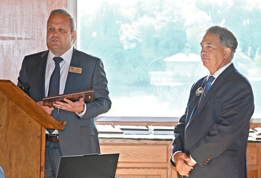 Outgoing board director John Calabrese, of the Rome Area Chamber of Commerce, left, recognized the 20 years of service of board member Mike Manuele, who retired this year. Manuele and many others were recognized at the chamber&rsquo;s annual meeting on Thursday.