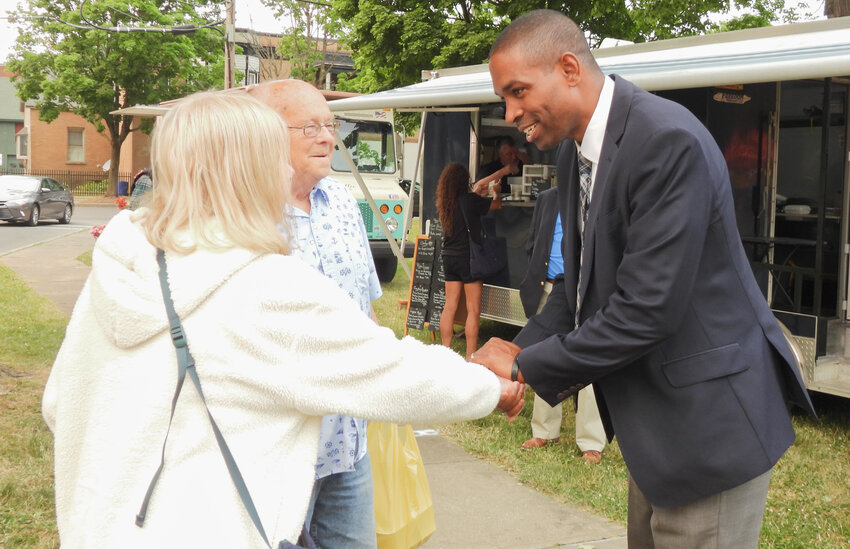 Lt. Gov. Antonio Delgado shakes hands with Debbie Crumb, of Holland Patent, after speaking with her and her husband, Francis, at the Whitesboro Farmers Market on Monday, June 5.