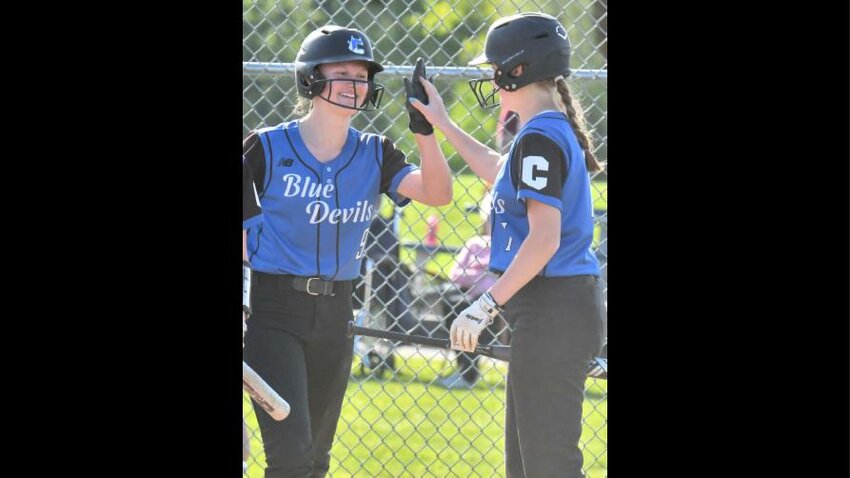 Brooke Musch, left, gets a high five from Camden teammate Camryn Shenk after she hit an inside-the-park home run this season at Whitesboro. Musch, a junior, has been named the Tri-Valley League softball player of the year for her role in leading Camden to an undefeated regular season, including possible state records for runs scored and stolen bases in a single season.