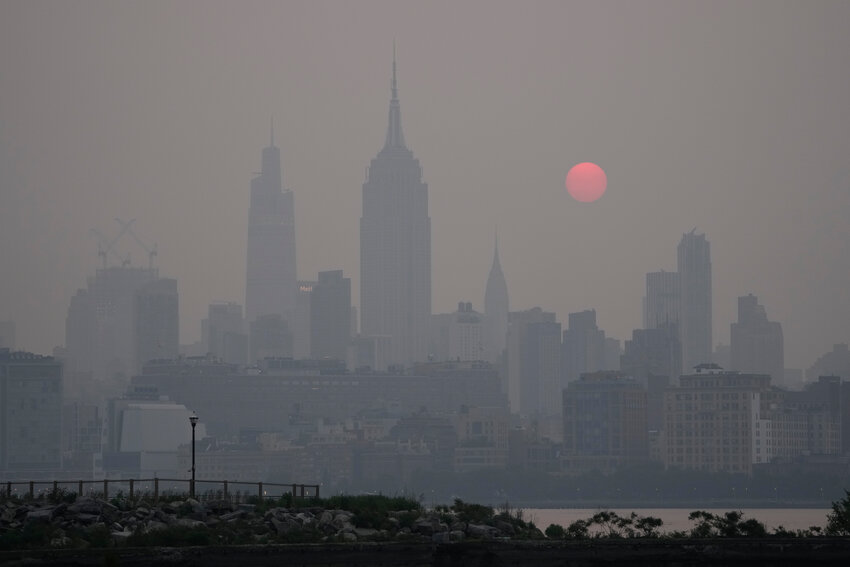 The sun rises over a hazy New York City skyline as seen from Jersey City, N.J., Wednesday, June 7, 2023. Intense Canadian wildfires are blanketing the northeastern U.S. in a dystopian haze, turning the air acrid, the sky yellowish gray and prompting warnings for vulnerable populations to stay inside.