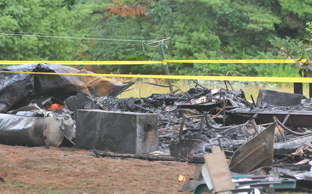 BURNED DEBRIS — Much of the mobile home was burned to the ground during the fatal fire at the Pine Haven mobile home park late Monday night.
 (Sentinel photo by John Clifford)