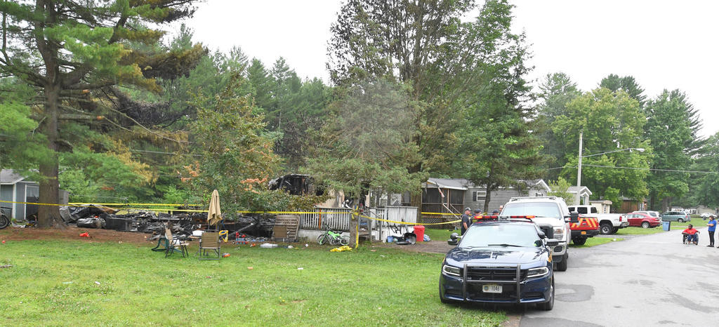 LOSS OF LIFE — State investigators and city fire officials surround the remains of a mobile home at the Pine Haven mobile home park where three children were killed late Monday night. The cause will be under investigation for some time. The parents, and the youngest of the four children, survived with minor burns, authorities said.
 (Sentinel photo by John Clifford)